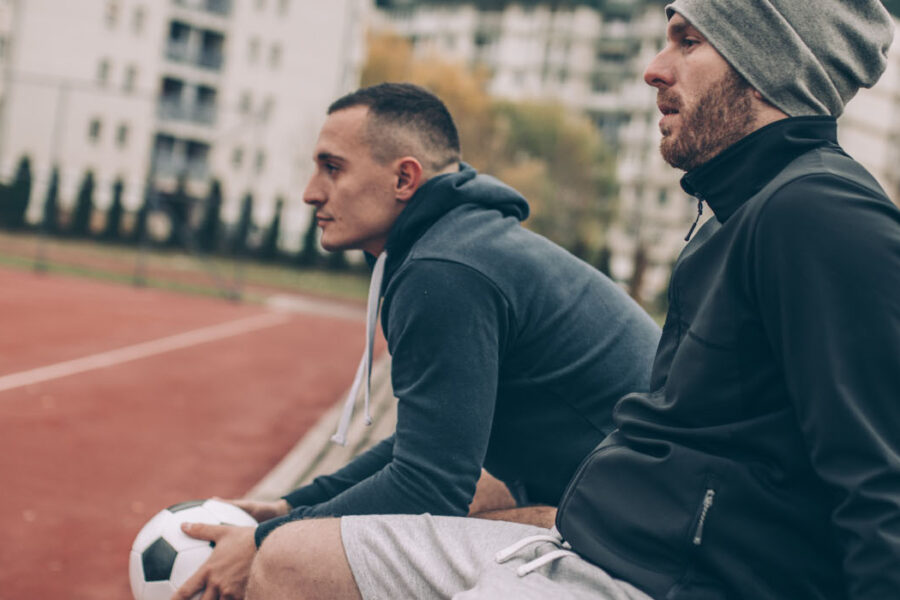 two guys sitting on a bench