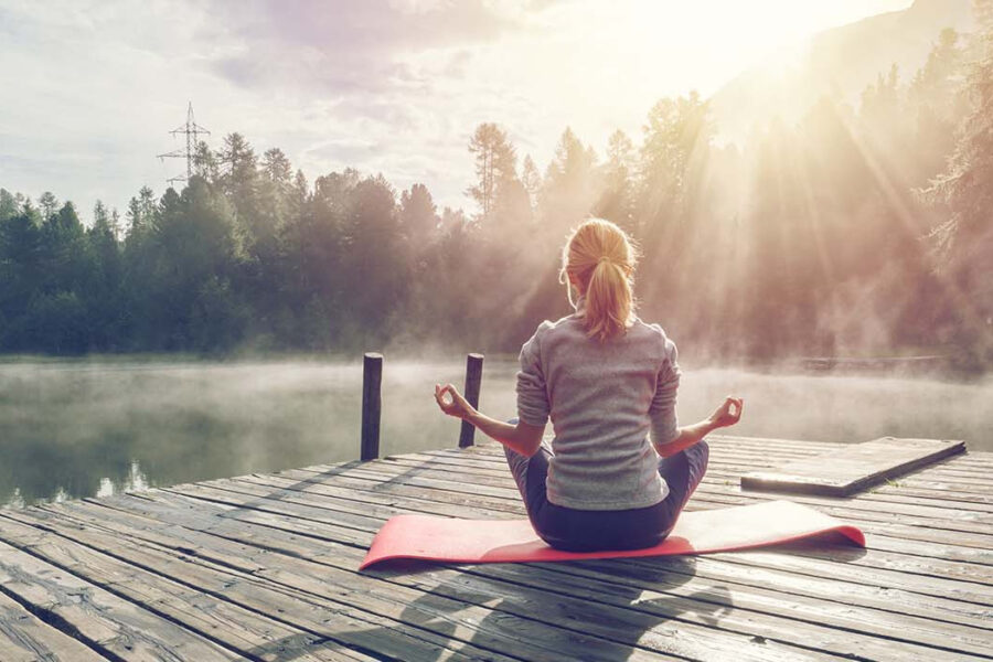 girl sitting on dock looking at water