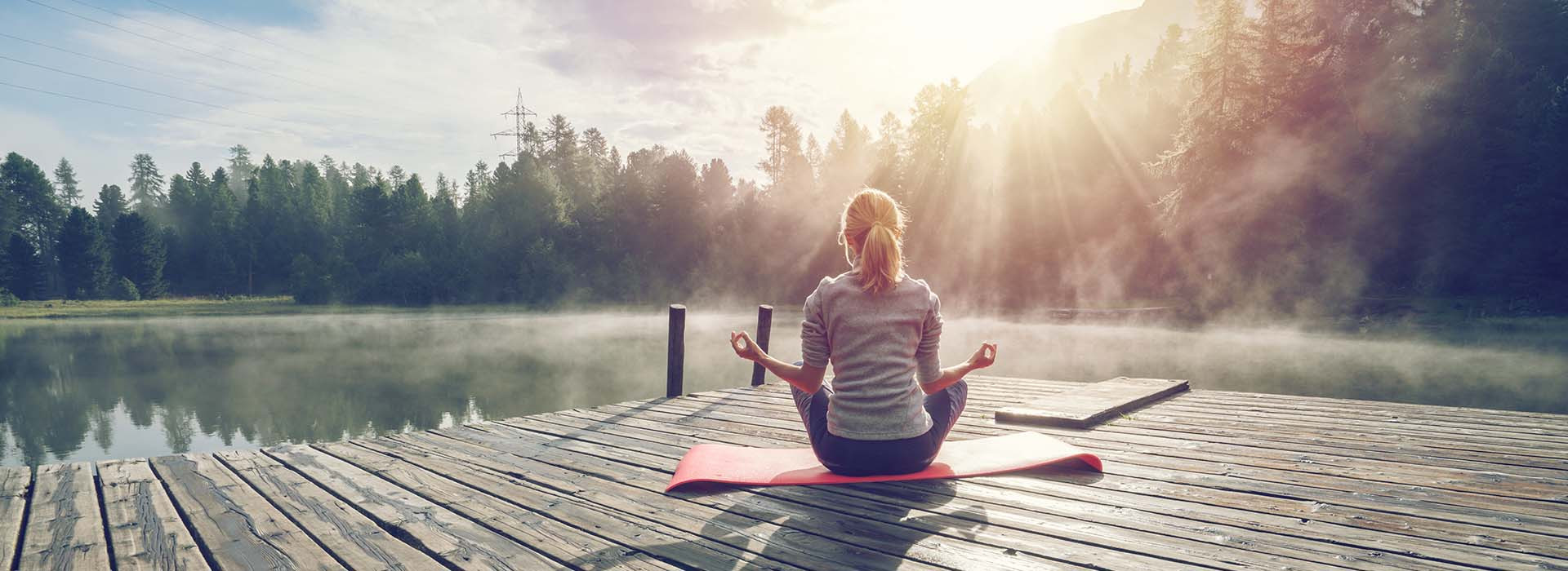 girl sitting on dock looking at water