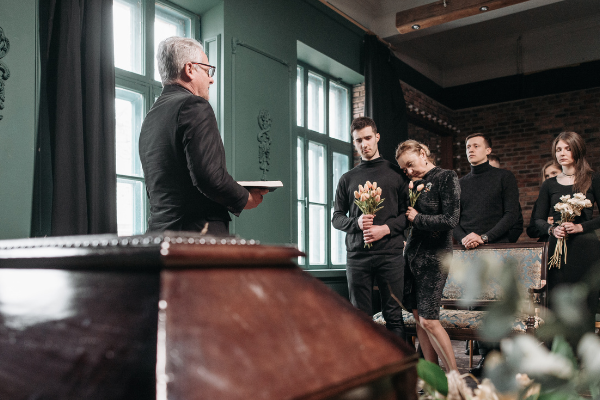 People gathered around to listen to funeral conductor